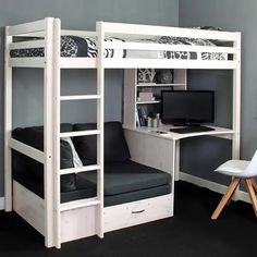 a white bunk bed sitting next to a desk