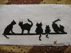 a piece of fabric with cats on it