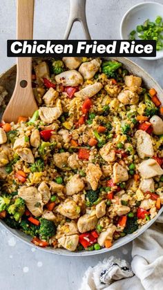 a skillet filled with chicken, broccoli and rice