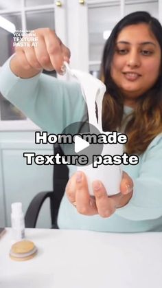 a woman is cutting paper with scissors on her fingers and the words home made texture paste in front of her