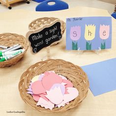 paper flowers in baskets on a table with writing and crafting supplies for children to make