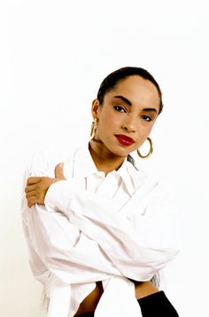 a woman with her arms crossed posing for a photo