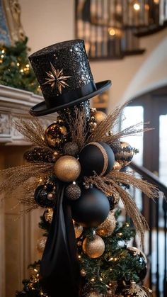 a christmas tree with a top hat on it's head and ornaments around the base