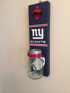 there is a mason jar hanging on the wall next to a new york giants sign