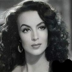 an old photo of a woman with curly hair and big hoop earrings on her head