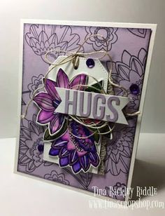 a close up of a greeting card with flowers on the front and purple, white, and black background