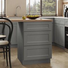 a kitchen with grey cabinets and an island