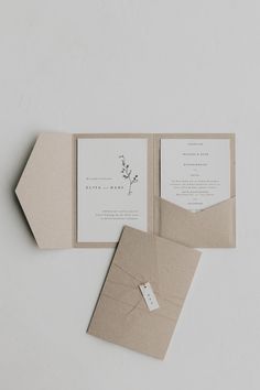 the wedding stationery is laid out on top of each other, with an envelope