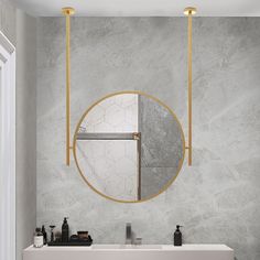 a bathroom with marble walls and gold fixtures