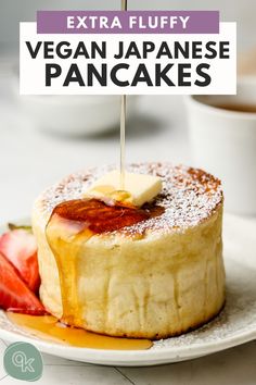 a pancake on a plate with strawberries and syrup being drizzled over it