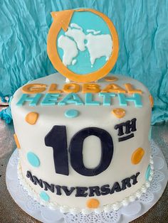 a cake with the number ten on it is decorated in blue, yellow and white