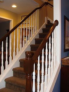 there is a stair case in the house with blue walls and brown carpet on the stairs