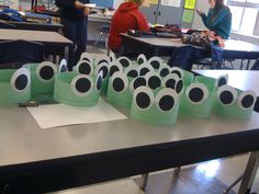 some green and white cups sitting on top of a table