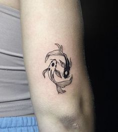 a woman's arm with a fish tattoo on it