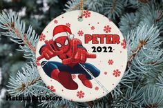 a spiderman ornament hanging from a christmas tree