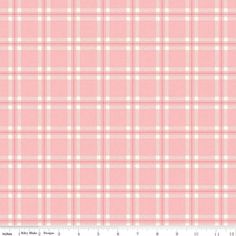 a pink and white checkered fabric with a ruler in front of the bottom half