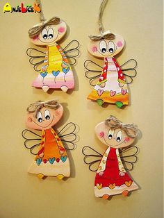 three wooden angel ornaments hanging on a wall