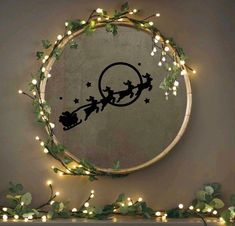 a circular mirror with christmas lights around it