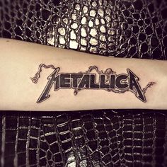 a tattoo with the word metallic on it