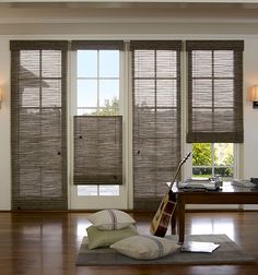 a living room filled with furniture and windows covered in blinds