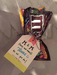 a candy bar wrapped in cellophane and tied to a tag