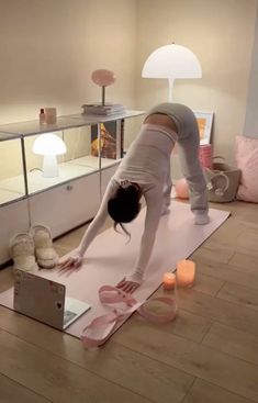 a woman is doing yoga in her living room