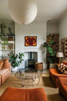 a living room filled with furniture and a fire place in the middle of the room