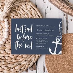 a blue and white wedding card with an anchor on it