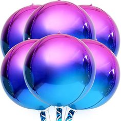 purple and blue balloons are stacked on top of each other in front of a white background