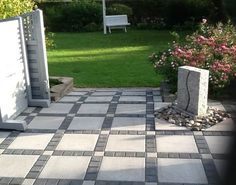 a stone bench sitting in the middle of a garden