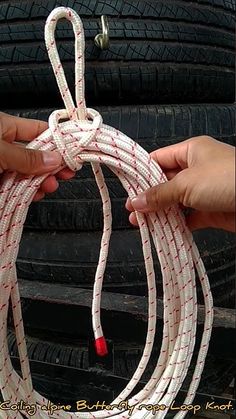 someone is holding the rope on top of their car tire, and it's not too long enough for them to pull off