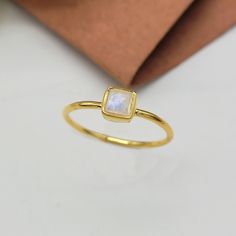 This Ring comes with a 100% Natural Rainbow Moonstone Gemstone and it is made up of 925 solid sterling silver. This ring is handcrafted by our skilled craftsmen and designed by us. Every gemstone is handpicked for the best quality.  Materials:- Silver (925 Solid Sterling Silver) Item Weight :- 1.5 Gram Approx. Gemstone:- Natural Rainbow Moonstone Stone Size :- 4MM Stone Shape :- Square Cab Select Size in Variation, if you don't find perfect size please buy any size and message us your size we'll Minimalist Yellow Gold Moonstone Ring In Sterling Silver, Minimalist Yellow Gold Sterling Silver Moonstone Ring, Minimalist Moonstone Ring As A Gift, Minimalist Bezel-set Moonstone Ring Gift, Rectangular Moonstone Ring Gift, Minimalist Square Cut Gemstone Ring, June Birthstone Ring, Solitaire Rings, Moonstone Stone