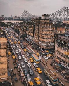 an aerial view of traffic on a busy city street with the cantile bridge in the background