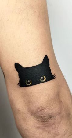 a black cat tattoo on the leg