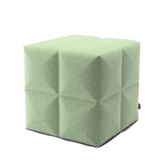 a green cube ottoman sitting on top of a white floor