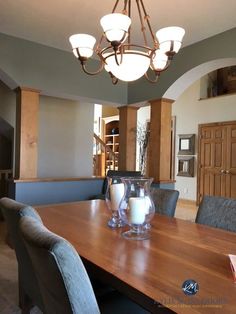 a dining room table with chairs and a chandelier