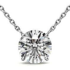 a round cut diamond on a chain with the center stone in white gold, set against a