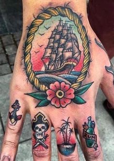 a person's hand with tattoos on it and a ship in the middle of their palm