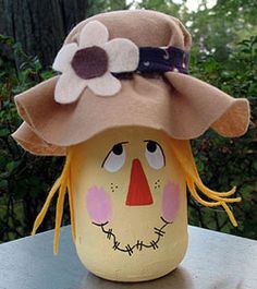 an egg wearing a scarecrow's hat with flowers on it