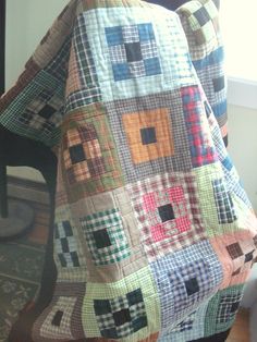 a chair that has a quilt on it