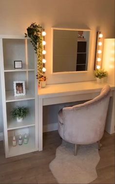 a white chair sitting in front of a vanity with lights on it's sides