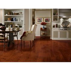 a dining room and kitchen area with wood flooring in the center, open shelving