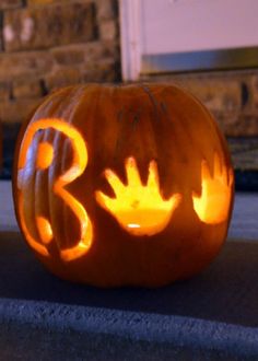 a carved pumpkin with the letter b carved into it