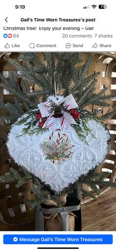 the christmas tree is decorated with white and red ribbon on it's own hanger