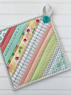 a close up of a piece of fabric on top of a white table with flowers and polka dots