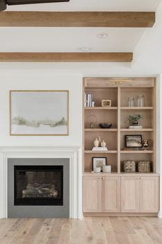 a living room filled with furniture and a fire place in front of a book shelf