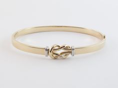 "Fabulous 14k Gold Love Knot Bangle Bracelet!! Material: Real 14k gold , Stamped 14k Weight: 7.10 grams Length: 7\" long Width: 10 mm wide on the knot and 5 mm wide on the tube Finish: Shiny yellow and white gold Closure: Hinged , Snap closure Gift box included Images may be enlarges to show details.Please pay attention to the photos and read description before the purchase. I ask you earnestly to make sure about measurements such as size , thickness, and length. Should you have any concerns or Adjustable 14k Gold Bracelet For Formal Occasions, Adjustable 14k Gold Bangle For Wedding, Adjustable 14k Gold Bangle With Polished Finish, 14k Gold Hallmarked Cuff Bracelet For Anniversary, 14k Gold Cuff Bracelet For Anniversary, Elegant Adjustable Gold Bracelet With Gold Clasp, 14k Gold Jubilee Bracelet For Wedding, 14k White Gold Cuff Bracelet Gift, Hallmarked 14k Gold Cuff Bracelet For Anniversary