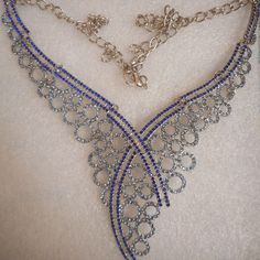 a very pretty blue and silver necklace on display