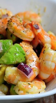 a white bowl filled with shrimp and vegetables