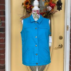 Super Cute And Vibrant Seaport Blue Vest! Has 4 Pockets On Outside And 2 Secret Pockets On Inside! Great Piece Of Clothing For Your Closet! 98% Cotton, 2% Spandex! Bust 20in Across, Shoulder To Bottom: 24.5in. Blue Tops With Snap Buttons For Fall, Blue Snap Buttons Tops For Fall, Blue Snap Button Tops For Fall, Spring Button-up Denim Vest With Pockets, Blue Button-up Denim Vest With Pockets, Faux Suede Vest, Medium Wash Button-up Denim Vest With Pockets, Floral Vests, Sleeveless Sweater Vest